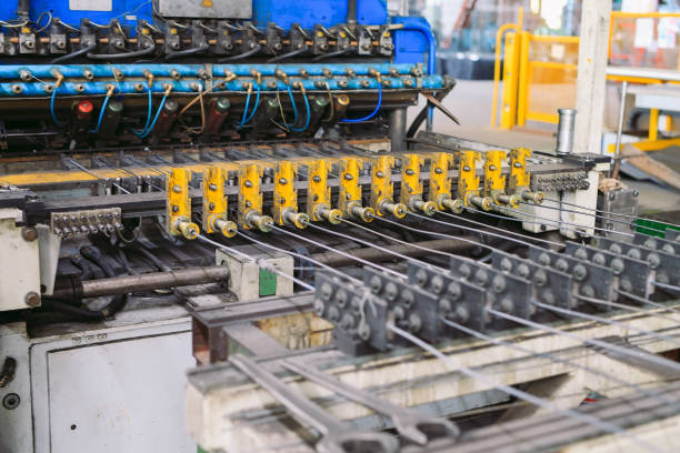 steel wire metal feeding into bending machine in the industrial factory.