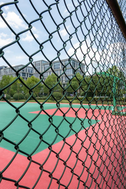 basketball court behind barbed wire