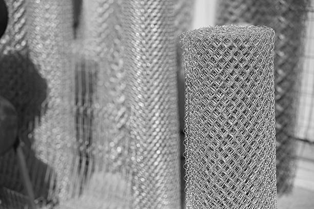 rolls of metal chain link fence mesh waiting for use in a commercial setting